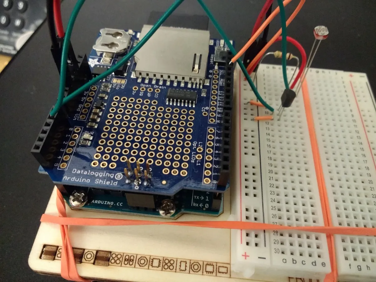 Arduino with data logger shield and breadboard setup for real-time environmental sensing and logging.
