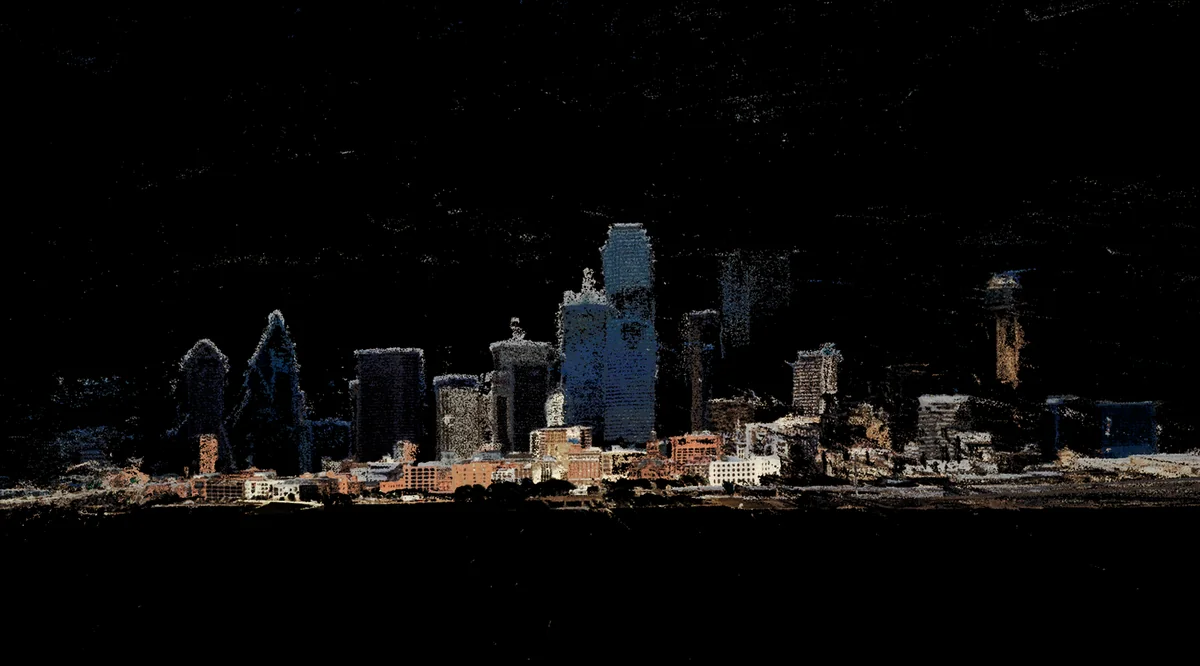 Photogrammetry mesh of a city skyline with fragmented, glowing buildings and textured surfaces against a dark background.