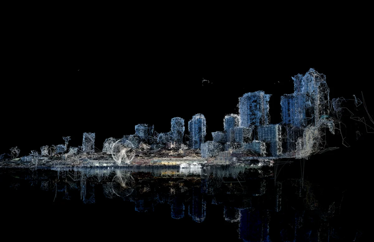 Photogrammetry mesh of a city skyline with fragmented, glowing buildings and textured surfaces against a dark background.