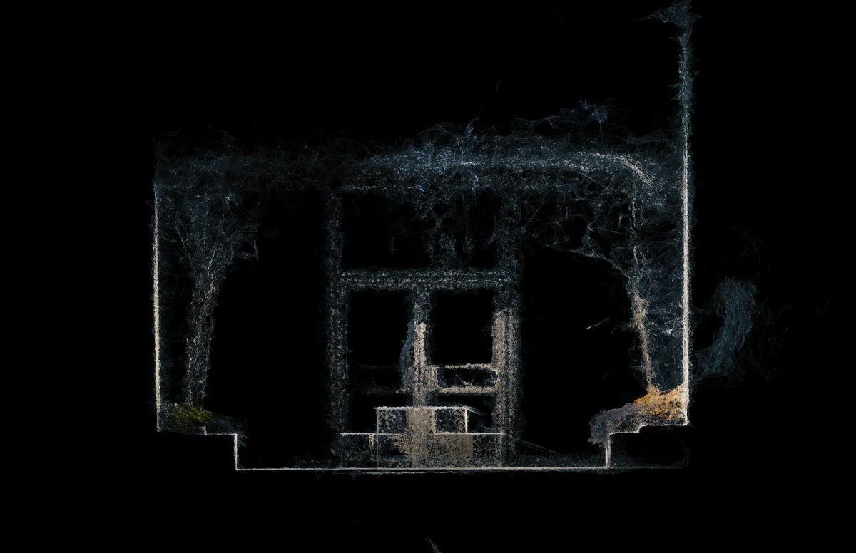 Photogrammetry mesh of a fragmented architectural interior with glowing edges and textured surfaces against a dark background.